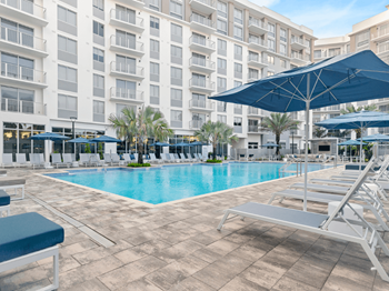 Resort-style heated pool with cabanas, sun deck, and lap lane
